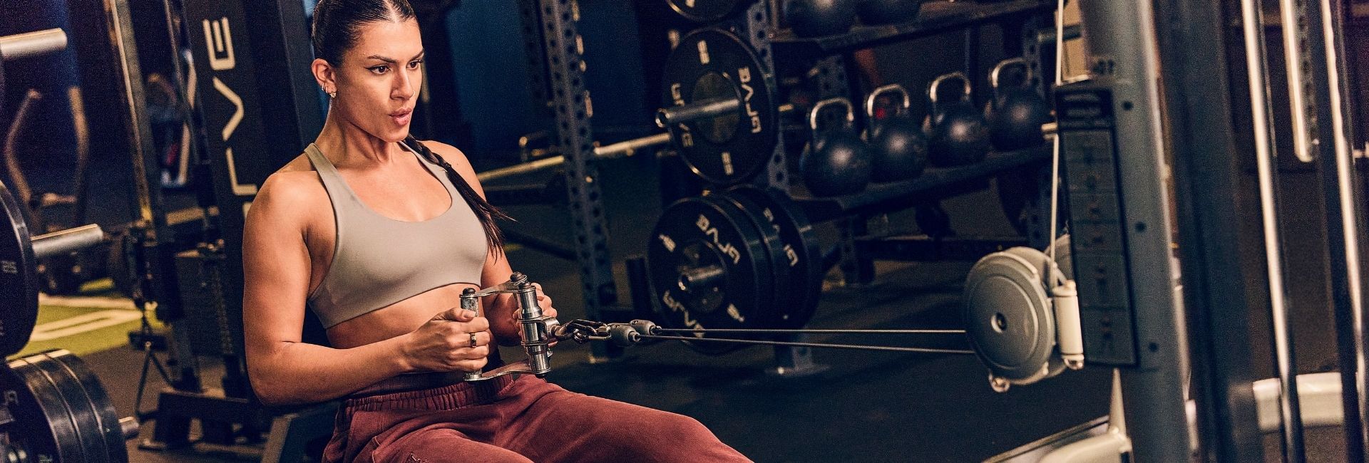 Woman performing seated cable row at Gold's Gym Arvada — pre-sale membership now open