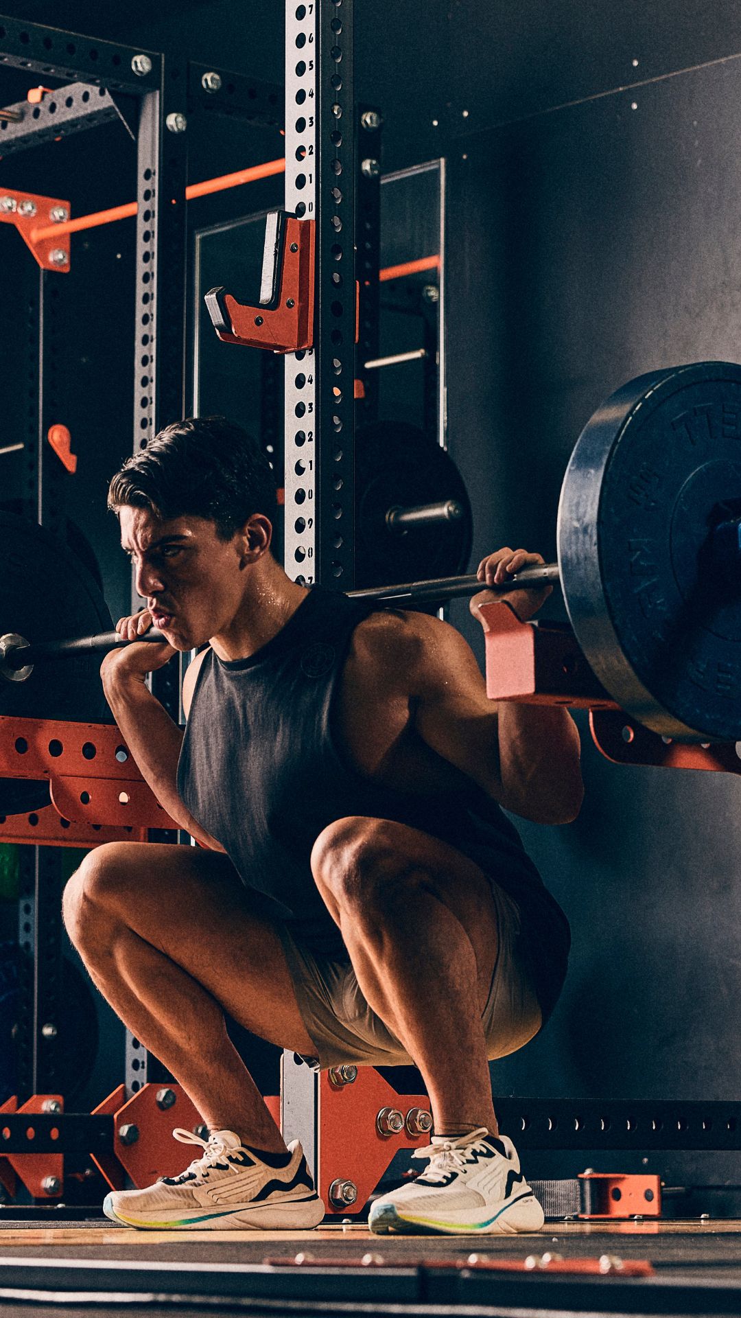 Lifter performing a heavy back squat on premium strength equipment at Gold’s Gym Arvada, showcasing the largest weight floor in Arvada for serious bodybuilding and strength training.