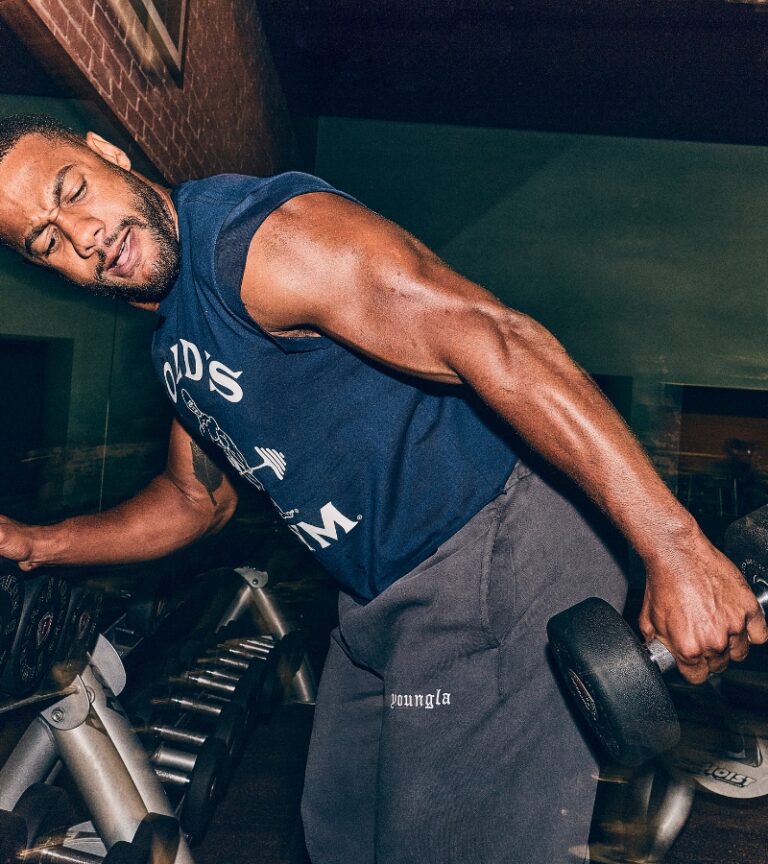 Member training with a dumbbell in the free weight area at Gold’s Gym Longmont, highlighting serious strength training and free weights