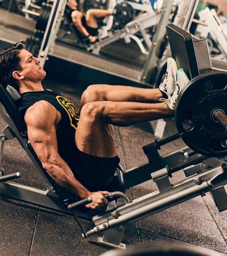 Member performing a heavy leg press at Gold’s Gym Longmont on plate-loaded strength equipment
