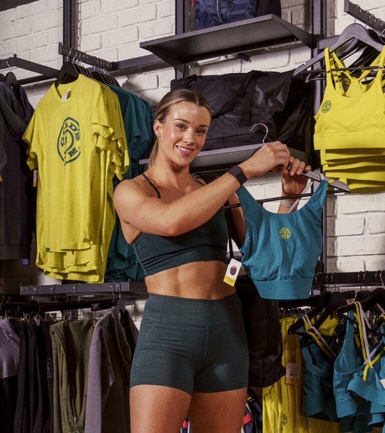 Member shopping Gold’s Gym branded sports bras and apparel in the pro shop at Gold’s Gym Longmont