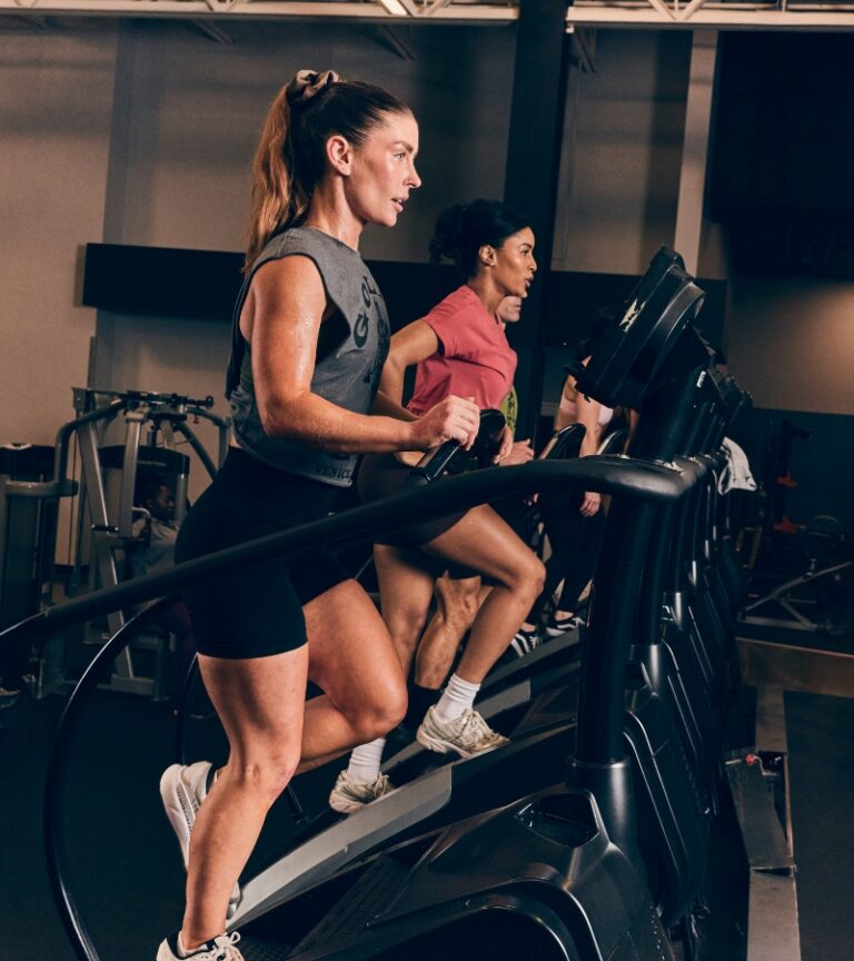 Members training on stair climber machines at Gold’s Gym Longmont in the cardio area, focused on high-intensity conditioning