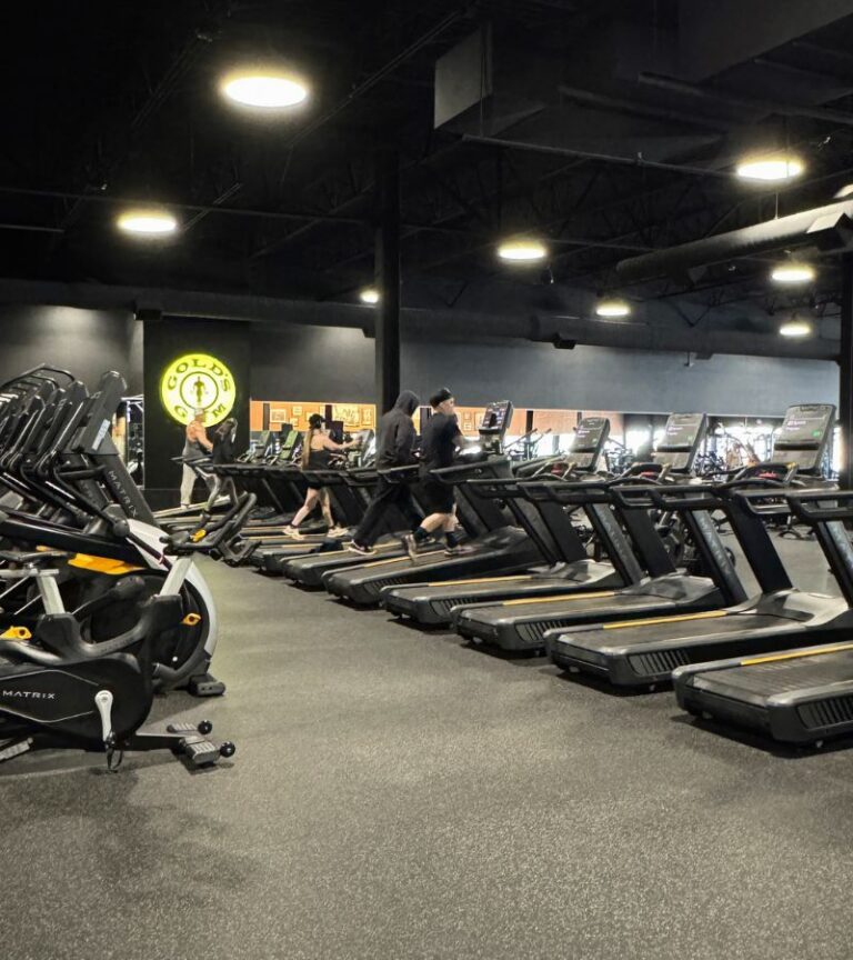 Members training on a row of treadmills at Gold’s Gym Thornton, highlighting the dedicated cardio area in a serious, performance-focused environment.