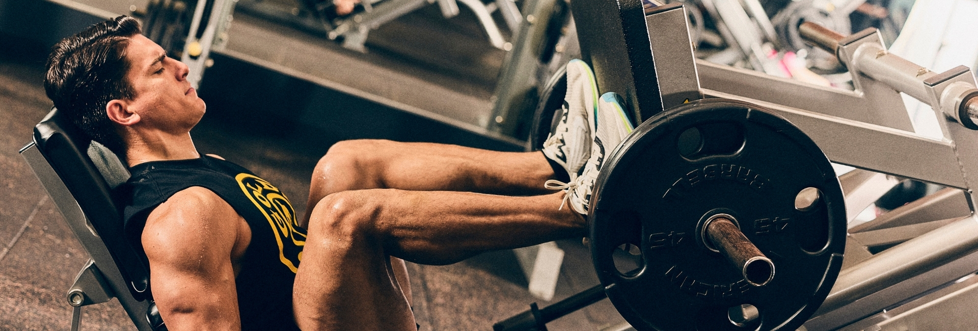 Member training on a leg press machine at Gold’s Gym Thornton, highlighting 24/7 strength access.