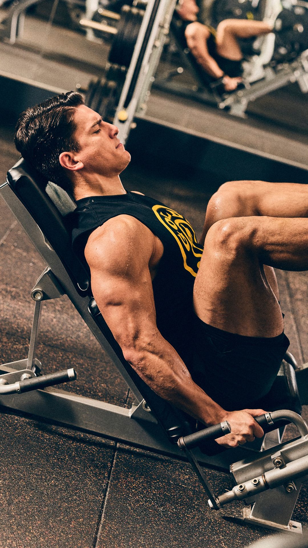 Member training on a leg press machine at Gold’s Gym Thornton, highlighting 24/7 strength access.