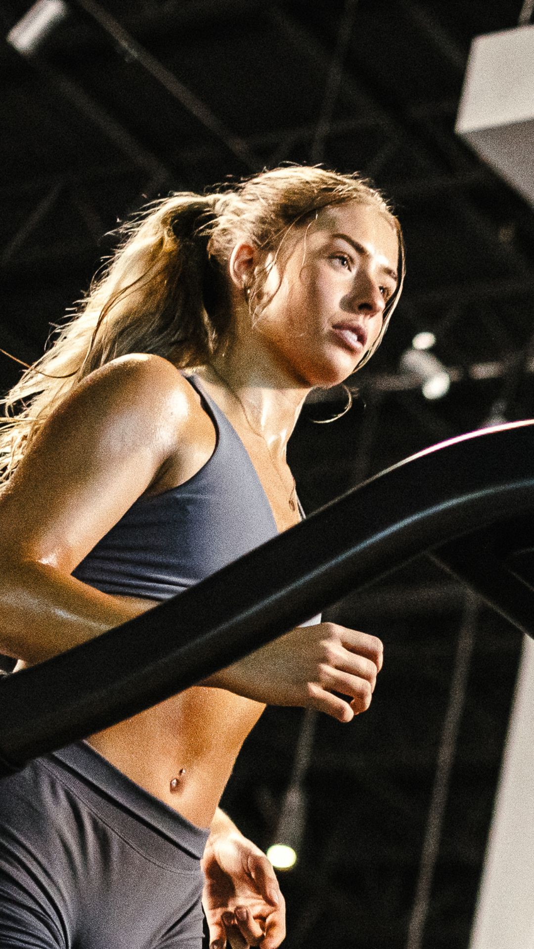 Woman running on treadmill during cardio workout at Gold's Gym